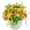 Radiating warmth like a sunlit Clapham afternoon, this bouquet brings together the joyous spirit of summer and autumn. Sunflowers, with bold velvet centres and luminous petals, anchor the arrangement, their golden glow inviting memories of walks through leafy Clapham South. Intertwined, creamy yellow roses unfurl delicately, each layer promising a celebration of happiness. Hints of vivid orange blossoms and accents of red berries pop through green foliage, adding playful energy that matches the buzz of the local high street. Soft ferns peek out, their feathery leaves adding gentle movement, reminiscent of the breeze on a summer terrace nearby. Arranged in a rounded glass vase, the bouquet lets the stems cross and mingle in a natural, artful display. A fresh, sweet fragrance-tinged with the green scent of foliage-drifts upward, as if the bouquet has just been gathered from Clapham's own gardens. Designed by a local Clapham florist with care, this arrangement brings unmistakable joy, perfect for celebrating milestones, saying thank you, or simply sharing a dose of sunshine with someone special in SW4.